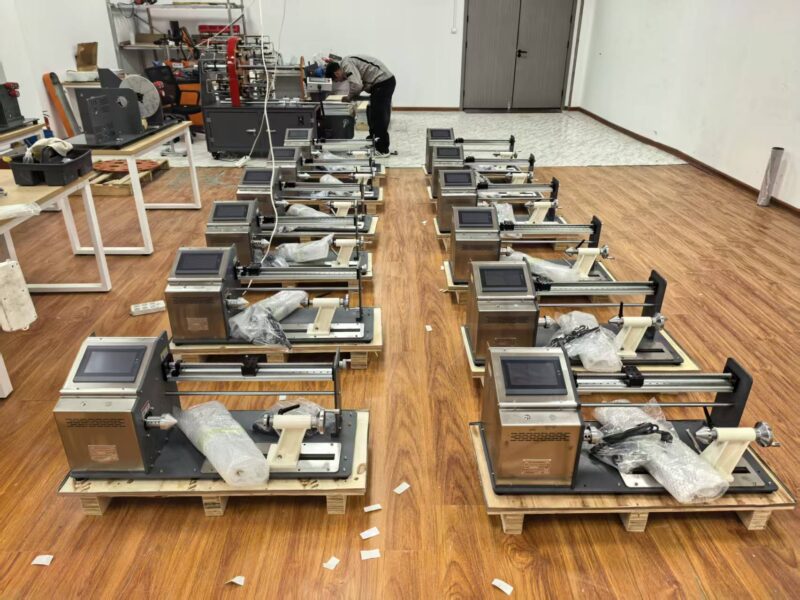 Rows of touch screen automatic winding machines on the factory floor