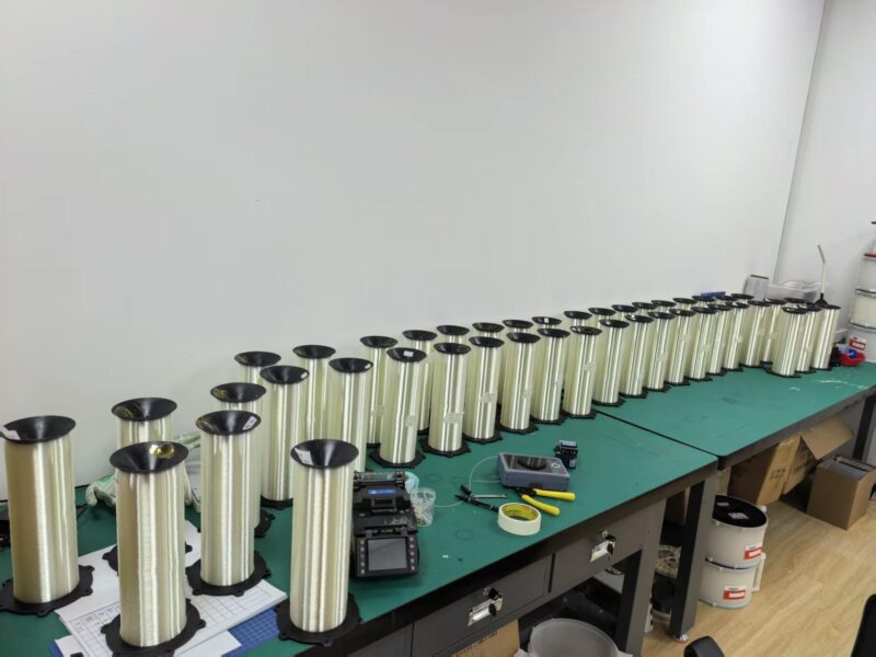 Fiber spools and winding equipment on an assembly bench