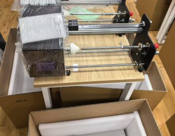 Compact fiber optic winding machines packed for shipment
